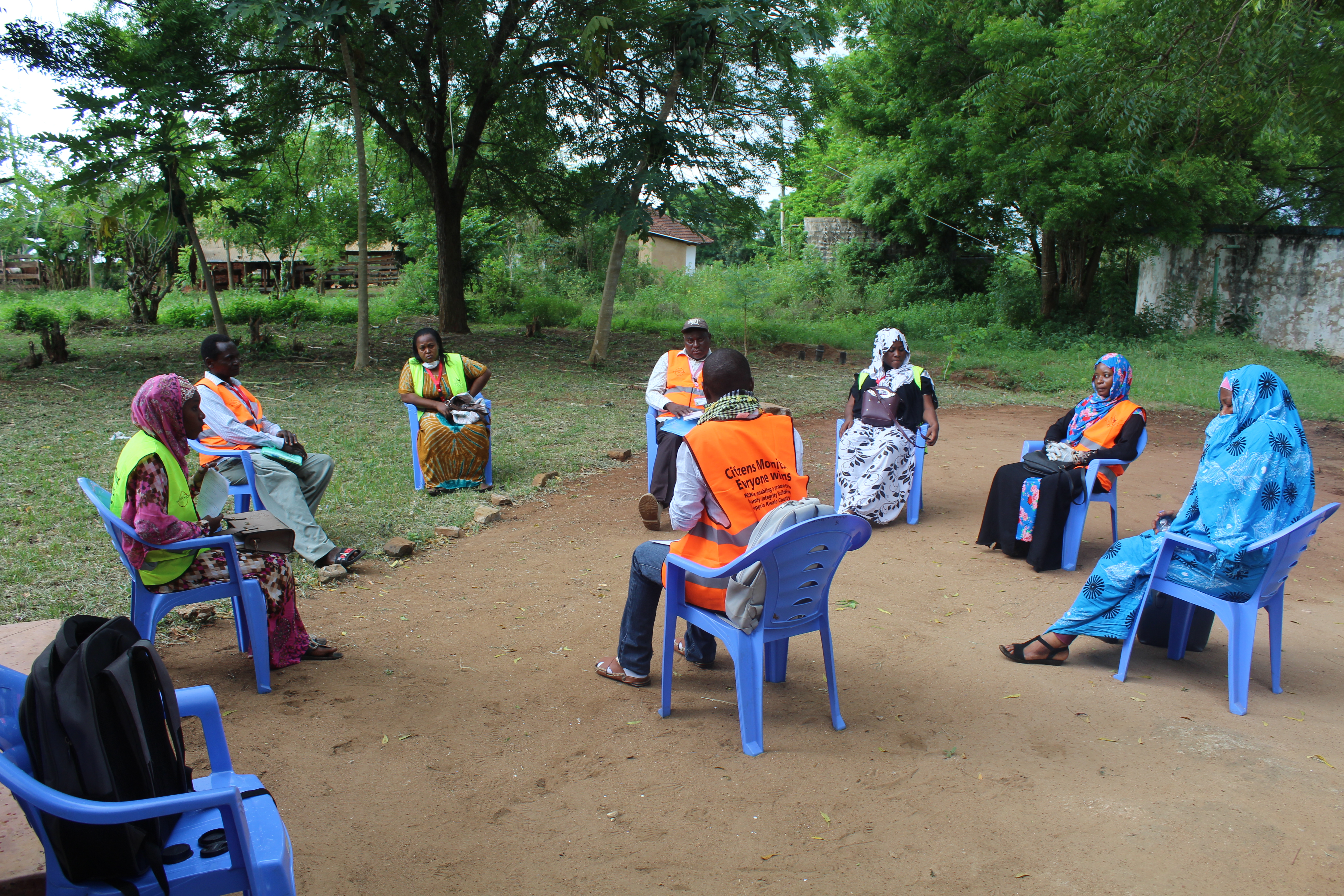 Community monitors discussing safe ways to continue activities at a distance